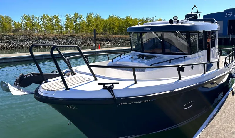 Sisu Yacht Photos Pics 2020 Sargo 31 boat docked at a marina on a sunny day.