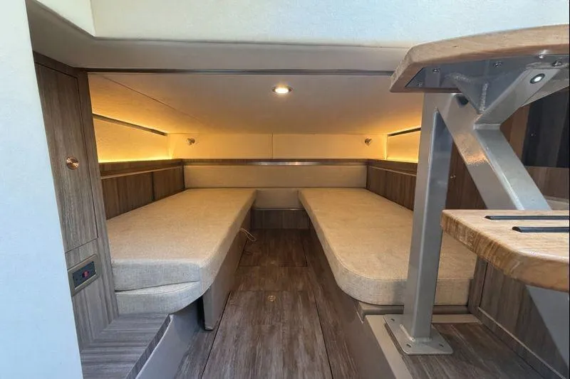 Sea Jay Yacht Photos Pics 2023 Sea Ray Sundancer 320 Outboard cabin interior with twin beds and modern wood finish.