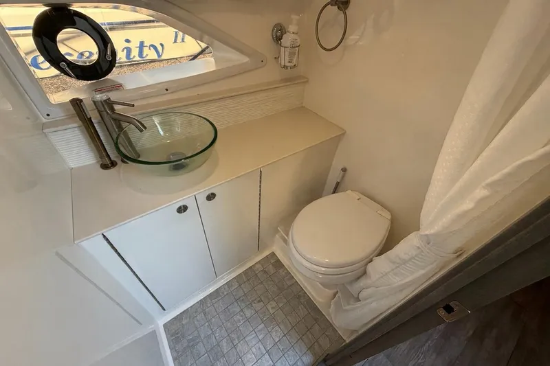 Sea Jay Yacht Photos Pics 2023 Sea Ray Sundancer 320 Outboard bathroom with modern sink and toilet.