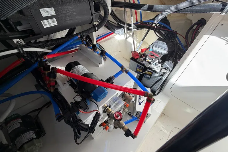 Sea Jay Yacht Photos Pics Engine compartment of 2023 Sea Ray Sundancer 320 Outboard with wiring and battery setup.