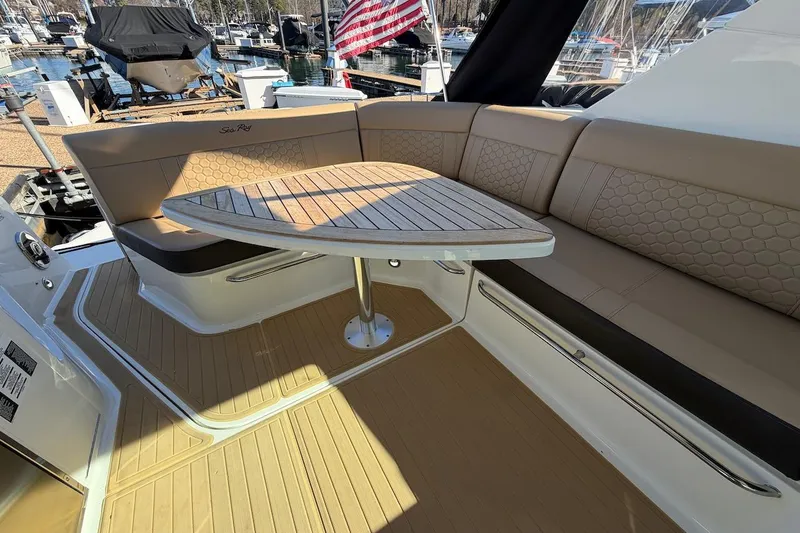 Sea Jay Yacht Photos Pics 2023 Sea Ray Sundancer 320 Outboard interior with elegant seating and wooden table.