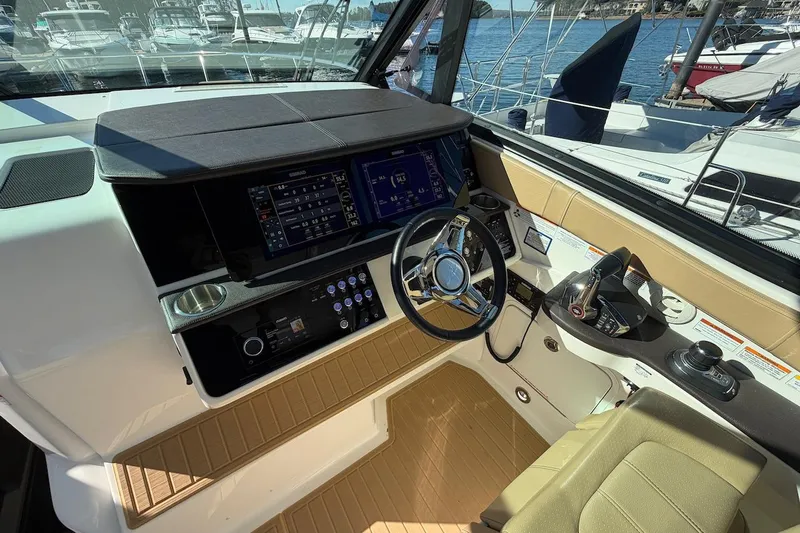 Sea Jay Yacht Photos Pics 2023 Sea Ray Sundancer 320 Outboard helm with modern controls and navigation displays.