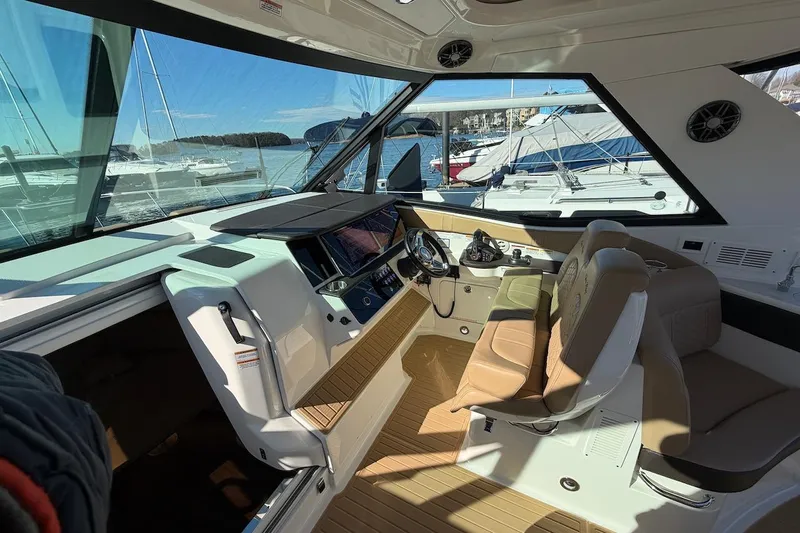 Sea Jay Yacht Photos Pics Interior of 2023 Sea Ray Sundancer 320 Outboard, featuring modern helm and seating.