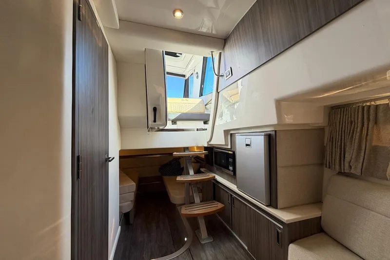 Sea Jay Yacht Photos Pics 2023 Sea Ray Sundancer 320 Outboard interior with modern kitchenette and seating area.