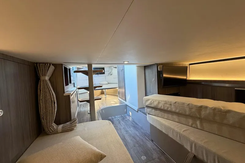 Sea Jay Yacht Photos Pics Luxurious interior of 2023 Sea Ray Sundancer 320 Outboard with modern furnishings and ambient lighting.