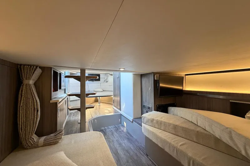 Sea Jay Yacht Photos Pics Luxurious interior of 2023 Sea Ray Sundancer 320 Outboard, featuring cozy seating and modern amenities.