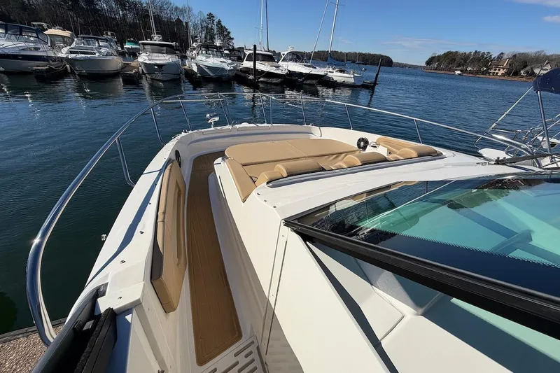Sea Jay Yacht Photos Pics 2023 Sea Ray Sundancer 320 Outboard docked at marina, featuring spacious deck and seating.
