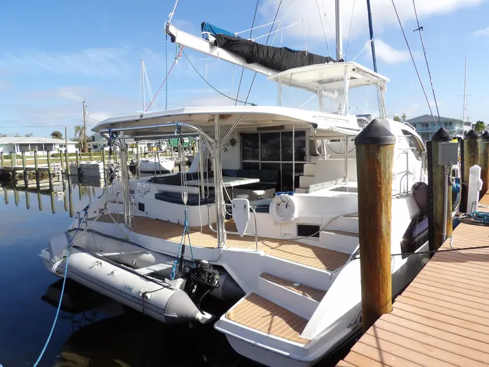  Yacht Photos Pics 2014 Leopard 48 catamaran docked, featuring spacious deck and modern design.