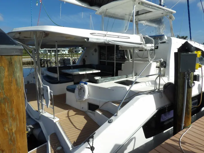  Yacht Photos Pics 2014 Leopard 48 yacht docked, featuring spacious deck and seating area.