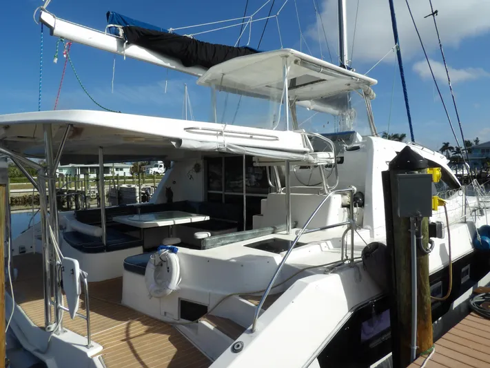  Yacht Photos Pics 2014 Leopard 48 catamaran docked, featuring spacious deck and seating area.