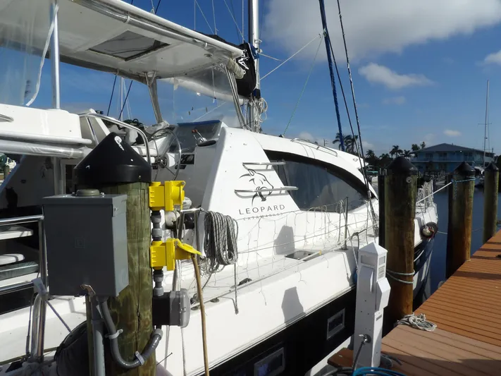 Yacht Photos Pics 2014 Leopard 48 yacht docked at marina under clear blue sky.