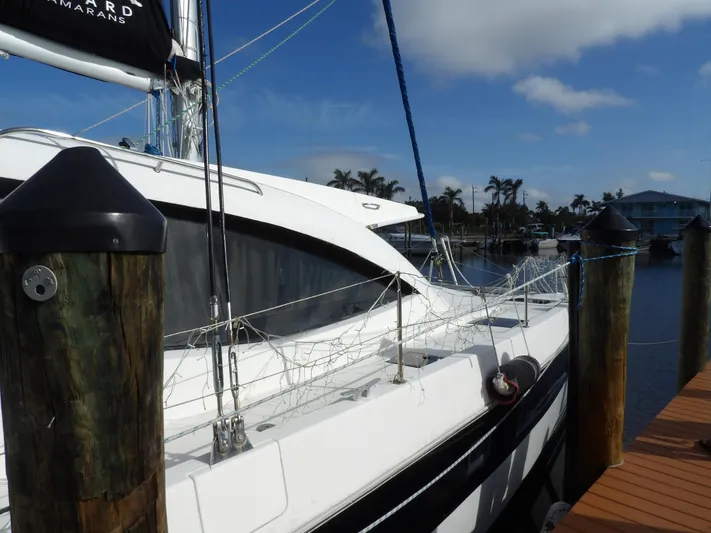  Yacht Photos Pics 2014 Leopard 48 yacht docked at marina under clear blue sky.