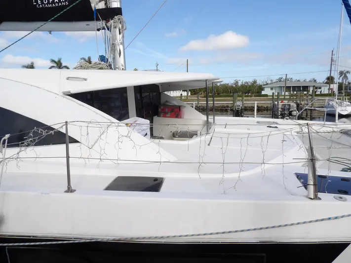  Yacht Photos Pics 2014 Leopard 48 catamaran docked, featuring sleek design and spacious deck.