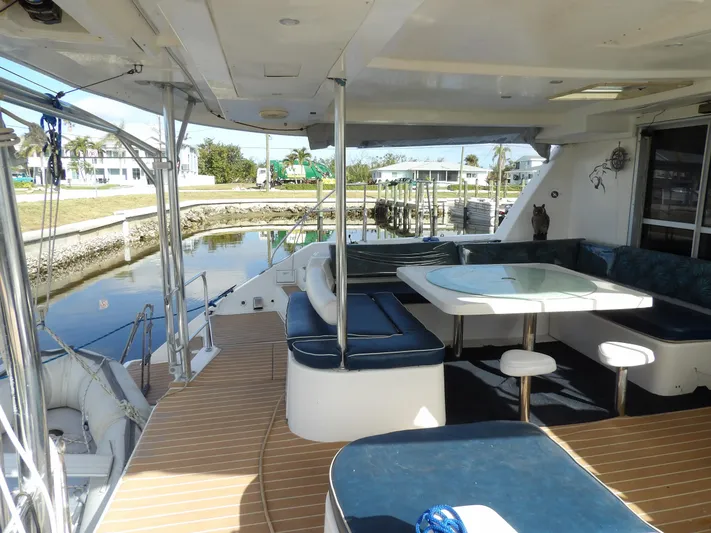  Yacht Photos Pics Spacious deck of 2014 Leopard 48 yacht with seating and dining area.
