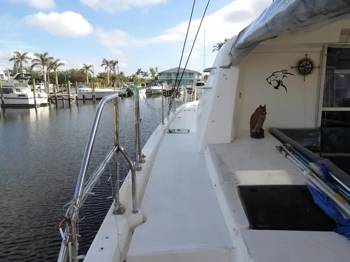  Yacht Photos Pics Leopard 48 yacht docked at marina, 2014 model, with clear skies and palm trees.