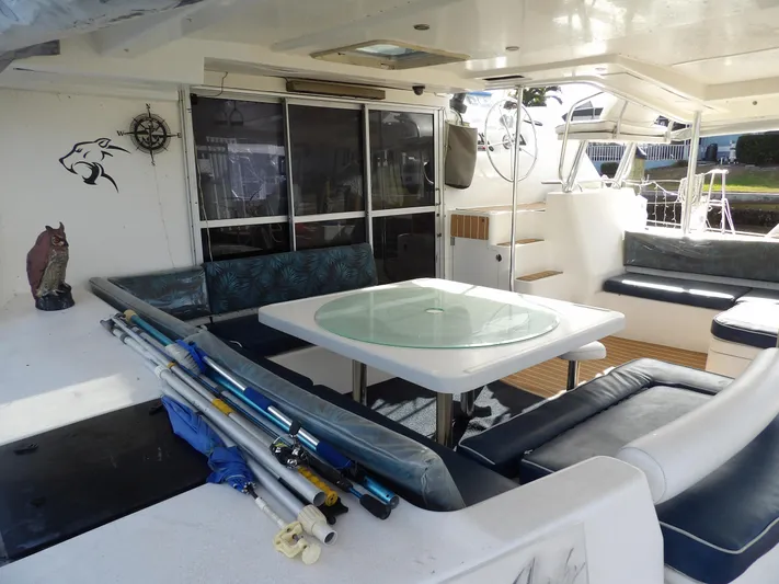  Yacht Photos Pics Spacious Leopard 48 yacht deck with seating, table, and fishing gear, 2014 model.