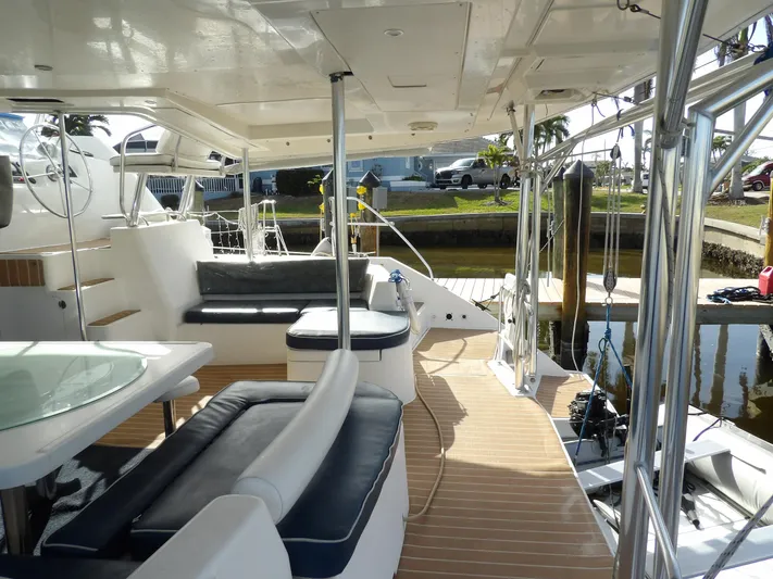  Yacht Photos Pics Spacious deck of 2014 Leopard 48 yacht with seating and table.
