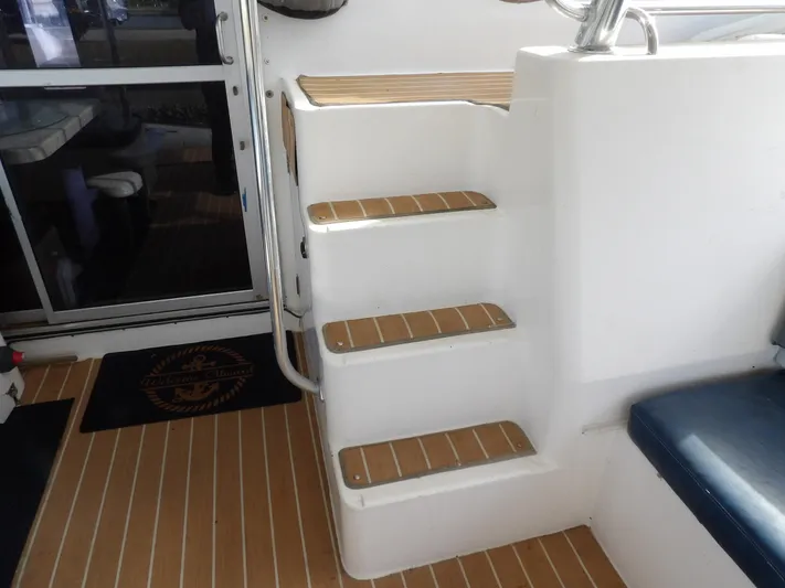  Yacht Photos Pics Staircase on 2014 Leopard 48 yacht with teak steps and blue seating.