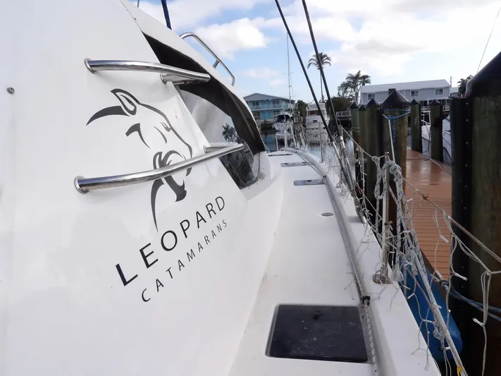  Yacht Photos Pics Leopard 48 catamaran docked, showcasing sleek design and logo, 2014 model.