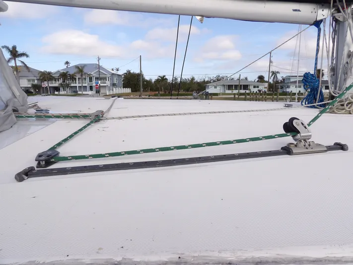  Yacht Photos Pics Leopard 48 sailboat deck with rigging, 2014 model, coastal homes in background.