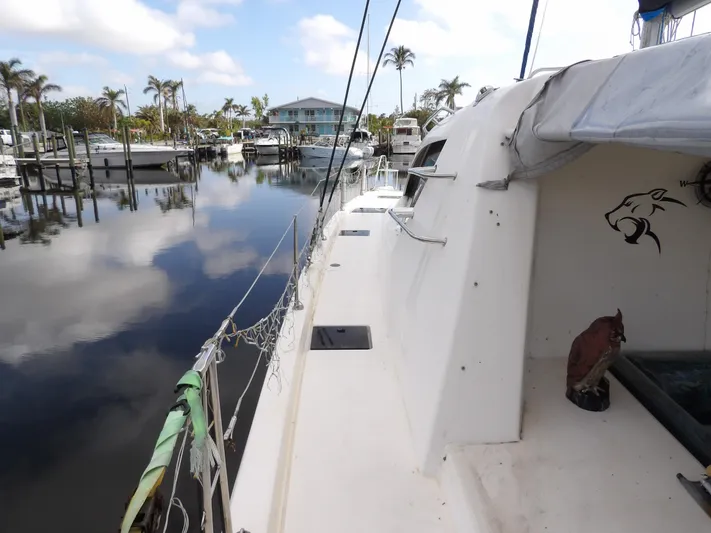  Yacht Photos Pics Leopard 48 catamaran docked in a marina, 2014 model, calm water reflections.