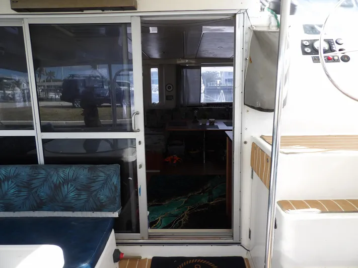  Yacht Photos Pics Interior view of 2014 Leopard 48 yacht with sliding glass door and seating area.