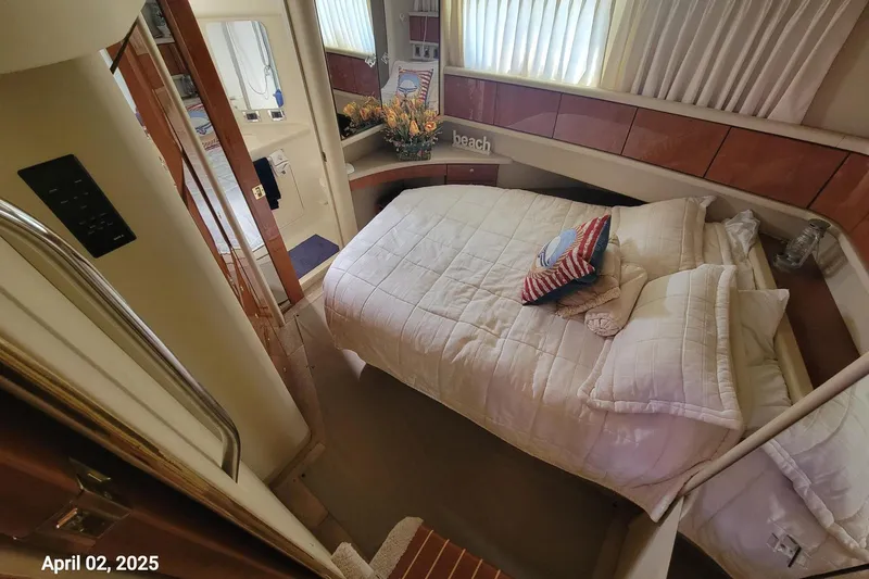 'next Week' Yacht Photos Pics Cozy bedroom in 2000 Sea Ray 380 Aft Cabin yacht with plush bedding and decor.