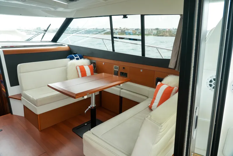 Dark Side Yacht Photos Pics Interior of 2017 Jeanneau NC11 yacht with elegant seating and table setup.