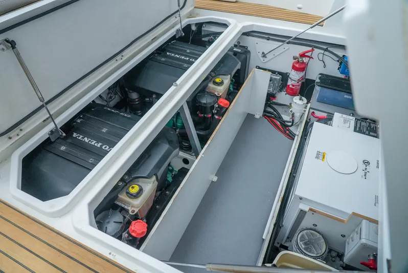 Dark Side Yacht Photos Pics Engine compartment of 2017 Jeanneau NC11 boat with visible components and fire extinguisher.