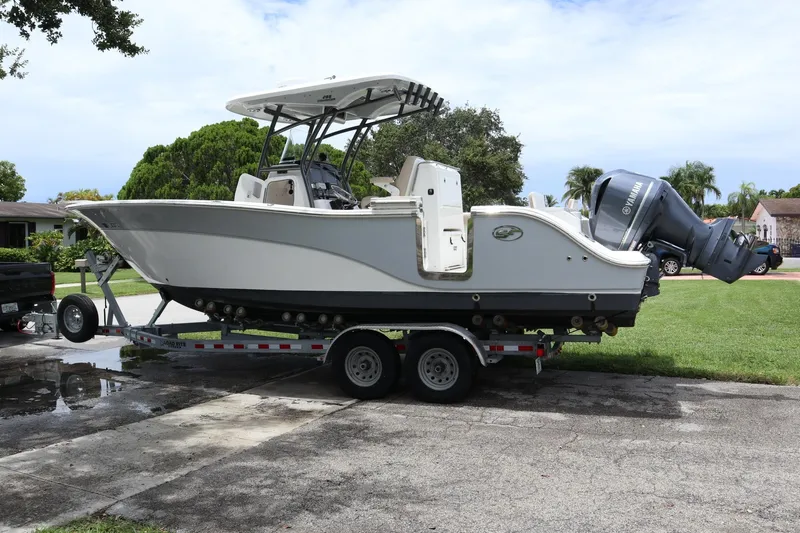  Yacht Photos Pics 2016 Sea Fox Commander 288 boat on trailer, parked in residential area.