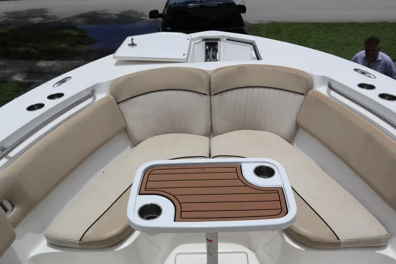  Yacht Photos Pics 2016 Sea Fox Commander 288 boat interior with cushioned seating and a wooden table.