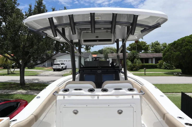  Yacht Photos Pics 2016 Sea Fox Commander 288 boat with T-top, parked in a residential area.