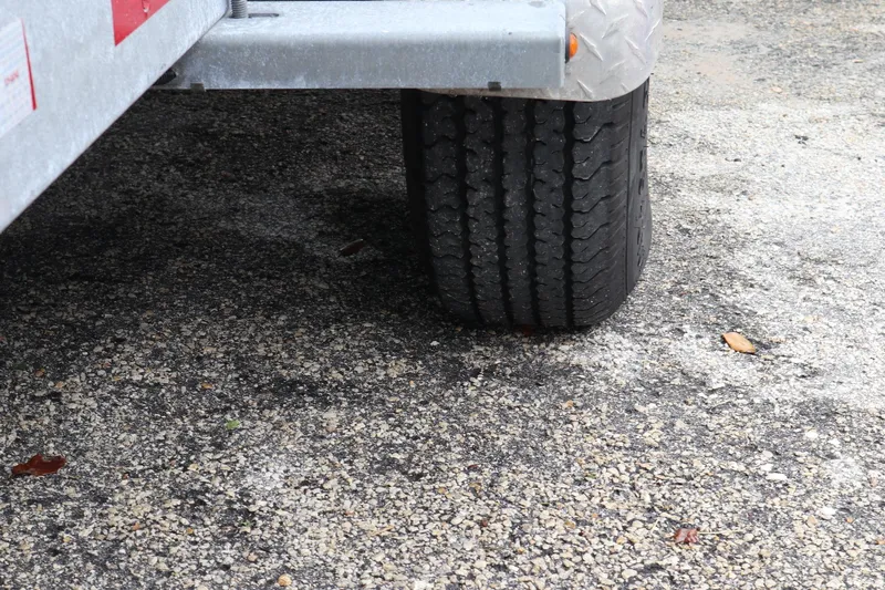  Yacht Photos Pics Trailer tire on pavement, part of a 2016 Sea Fox Commander 288.