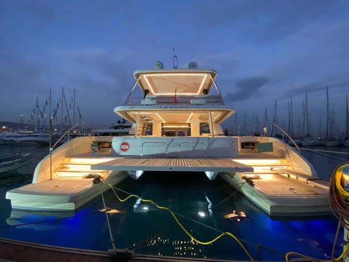 Ns03445 Yacht Photos Pics Luxurious 2022 Lagoon SIXTY 7 yacht illuminated at night in marina.