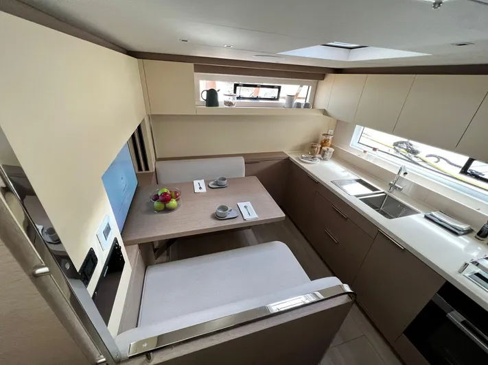 Ns03445 Yacht Photos Pics Luxurious 2022 Lagoon SIXTY 7 yacht interior with modern kitchen and dining area.