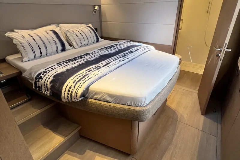 Ns03445 Yacht Photos Pics Luxurious bedroom interior of 2022 Lagoon SIXTY 7 yacht with modern bedding.