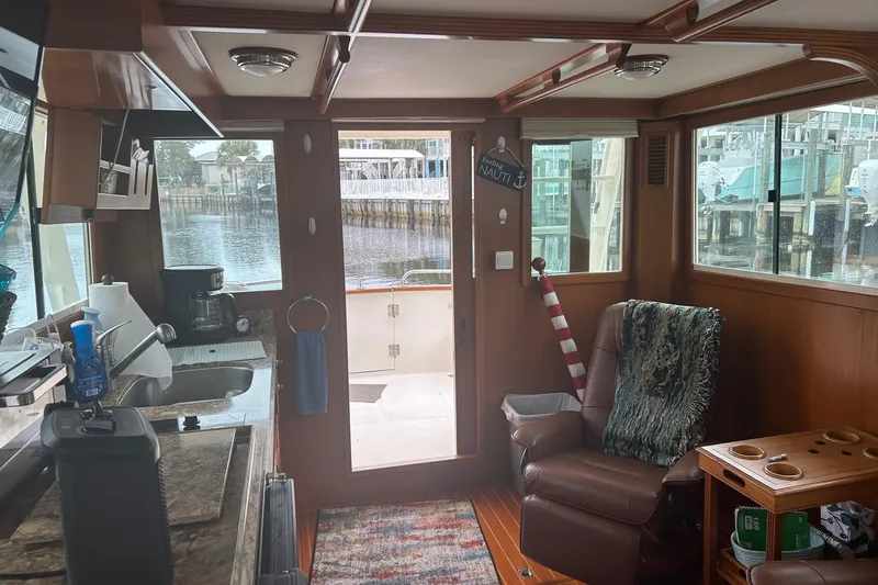  Yacht Photos Pics Interior of a 2006 Mariner Orient boat with cozy seating and kitchenette.