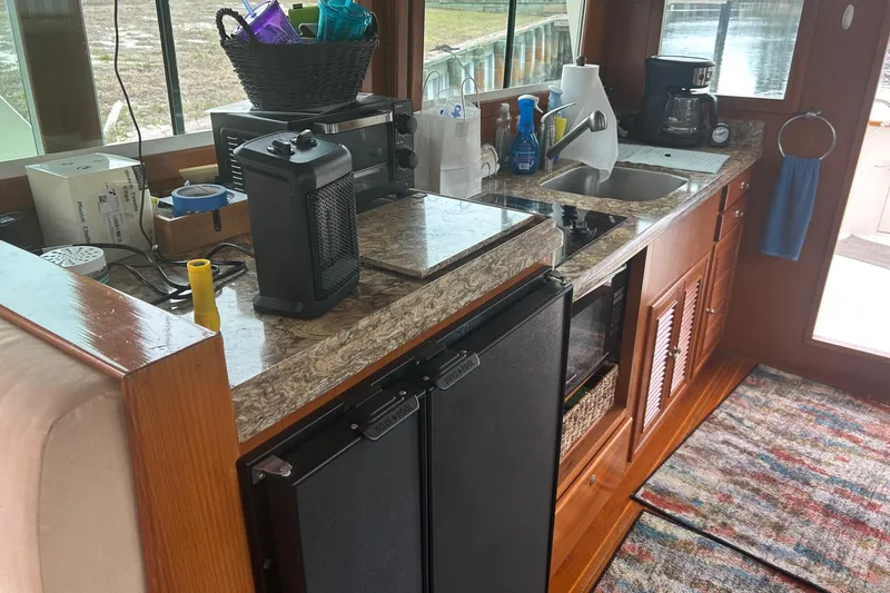  Yacht Photos Pics Compact kitchen area in a 2006 Mariner Orient boat with appliances and countertop essentials.