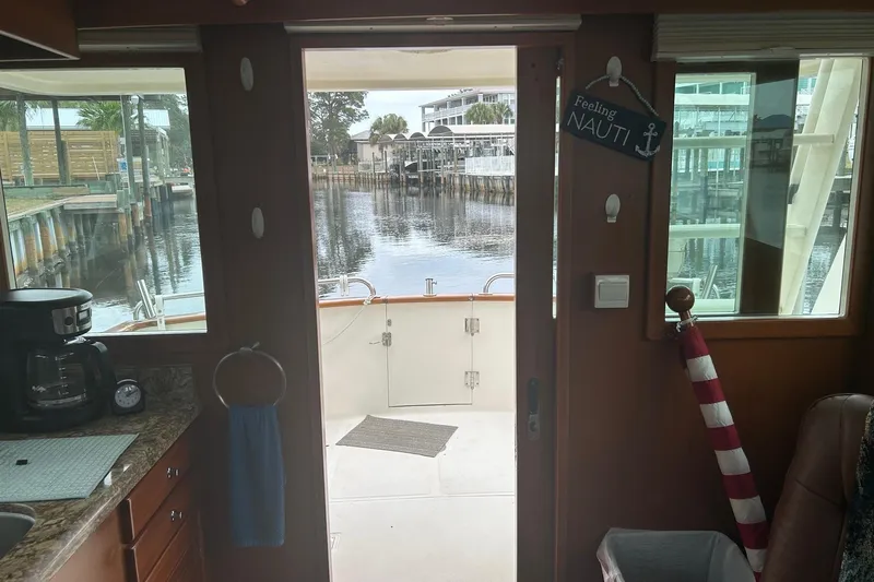  Yacht Photos Pics Interior view of 2006 Mariner Orient boat with dockside scenery through open door.