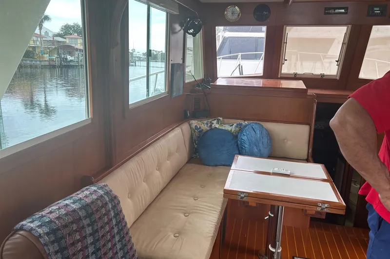  Yacht Photos Pics Interior of 2006 Mariner Orient boat with cozy seating and wooden table.