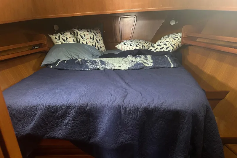  Yacht Photos Pics Cozy cabin bed in 2006 Mariner Orient boat with blue bedding and patterned pillows.