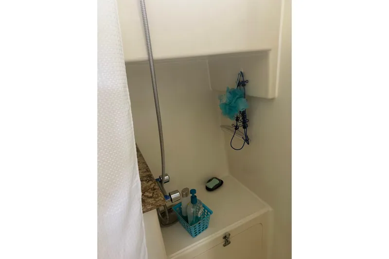  Yacht Photos Pics Compact shower area in 2006 Mariner Orient boat with toiletries and showerhead.