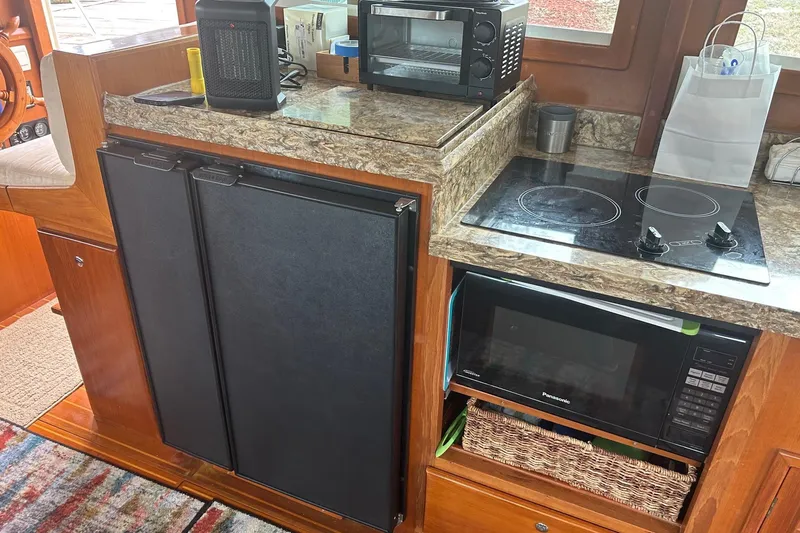  Yacht Photos Pics Compact kitchen area in a 2006 Mariner Orient boat with appliances and storage.