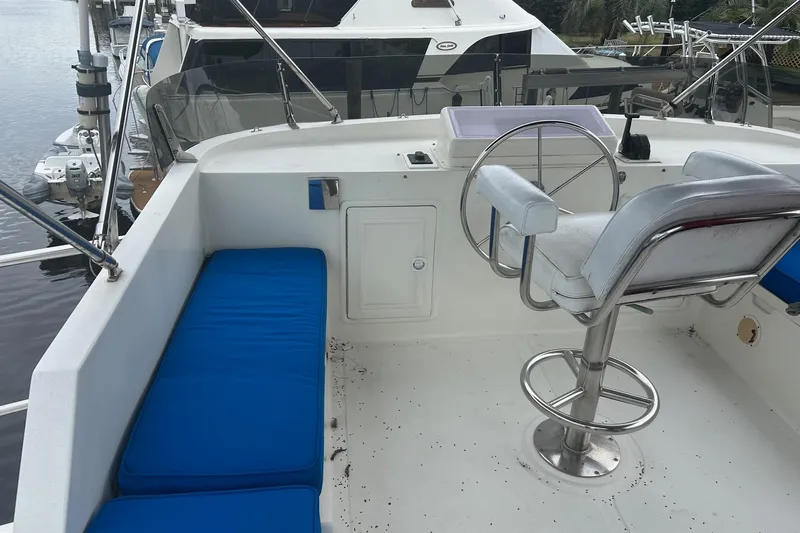  Yacht Photos Pics 2006 Mariner Orient boat helm with blue seating and steering wheel.