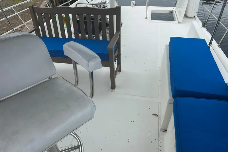  Yacht Photos Pics 2006 Mariner Orient boat deck with blue cushioned seating and railing.