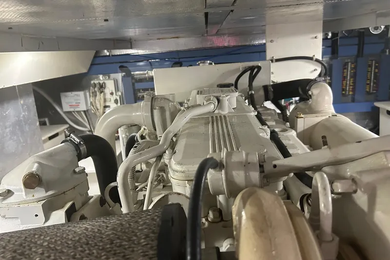  Yacht Photos Pics Engine room of a 2006 Mariner Orient boat, showcasing mechanical components and wiring.