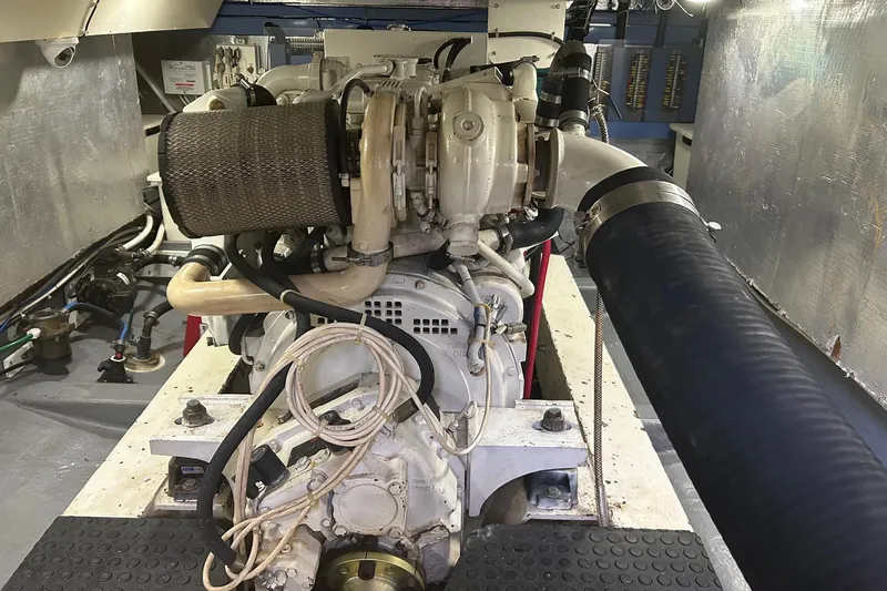  Yacht Photos Pics Engine room of a 2006 Mariner Orient boat, showcasing mechanical components and piping.