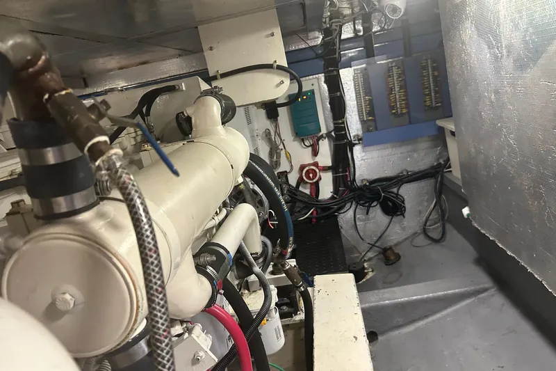  Yacht Photos Pics Engine room of a 2006 Mariner Orient boat, showcasing machinery and wiring.