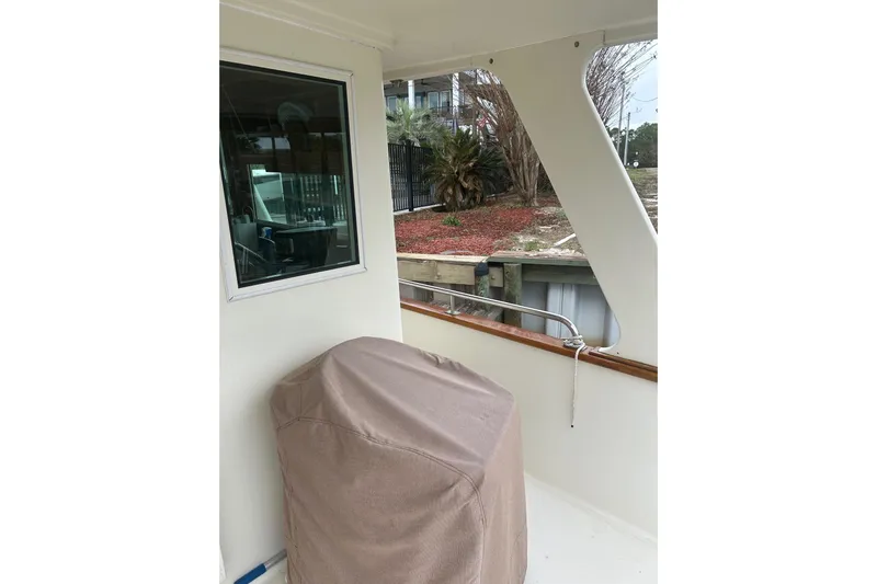  Yacht Photos Pics Covered equipment on 2006 Mariner Orient boat deck, near window and railing.