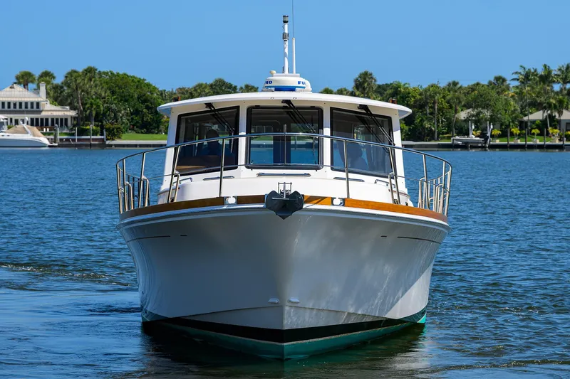 Seabird Yacht Photos Pics 2014 Grand Banks 46 Eastbay SX yacht on calm water, front view.